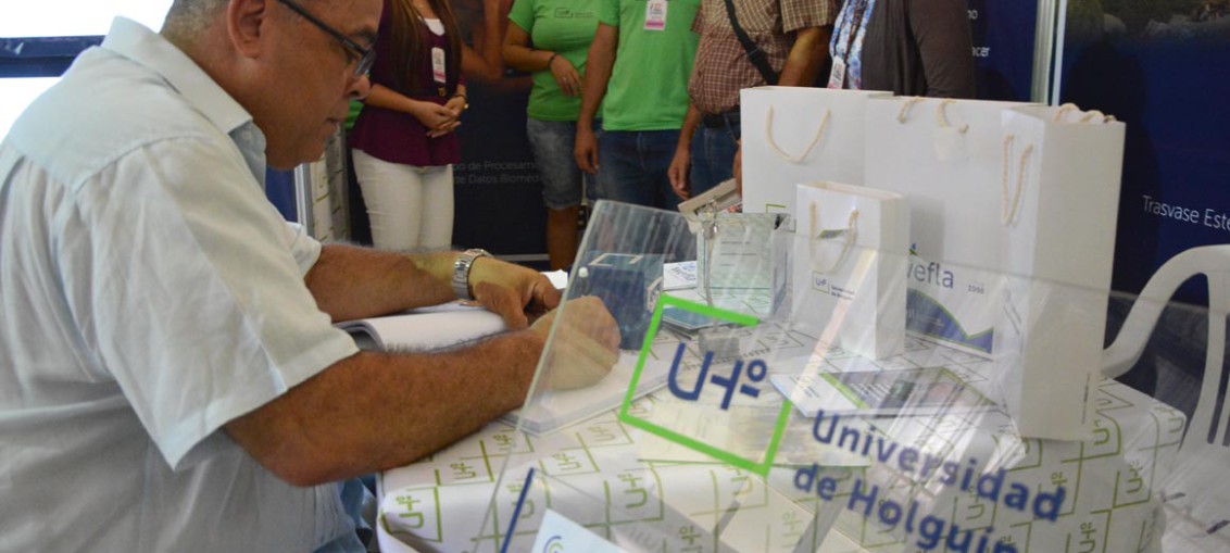 Luis Antonio Torres Iribar, Miembro del Comité Central y Primer Secretario del PCC en Holguín, escribe en el Libro de Visitantes de la Universidad de Holguín. UHo FOTO/Luis Ernesto Ruiz Martínez.
